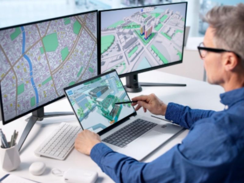 Professional reviewing metes and bounds property mapping data and digital land boundary plans on multiple screens